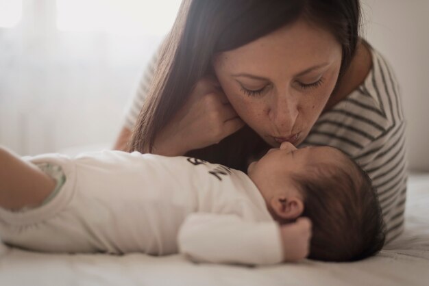 Mother kissing her little baby