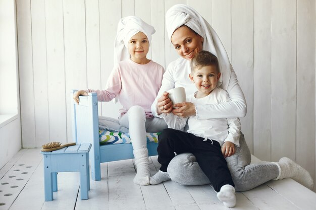 Mother and little children have fun at home