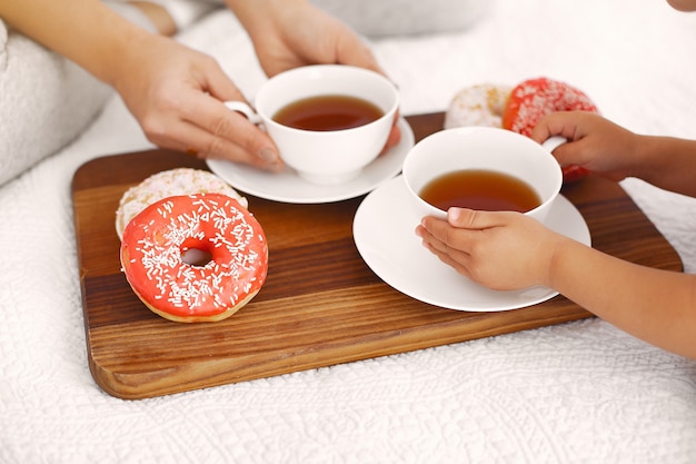 Mother and little daughter have a breakfast at home