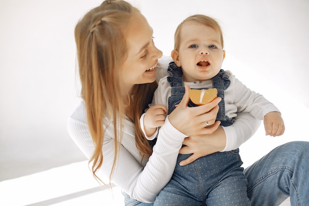 Mother and little daughter have fun at home