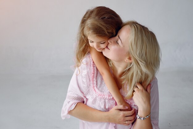 Mother and little daughter have fun at home