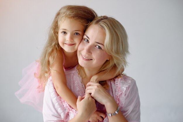 Mother and little daughter have fun at home