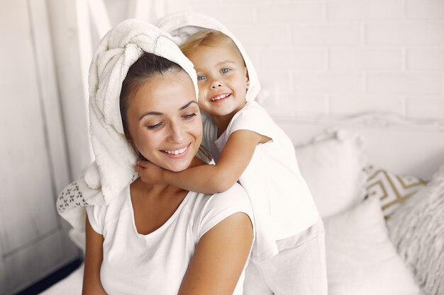 Mother and little daughter have fun at home