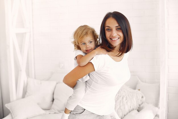 Mother and little daughter have fun at home