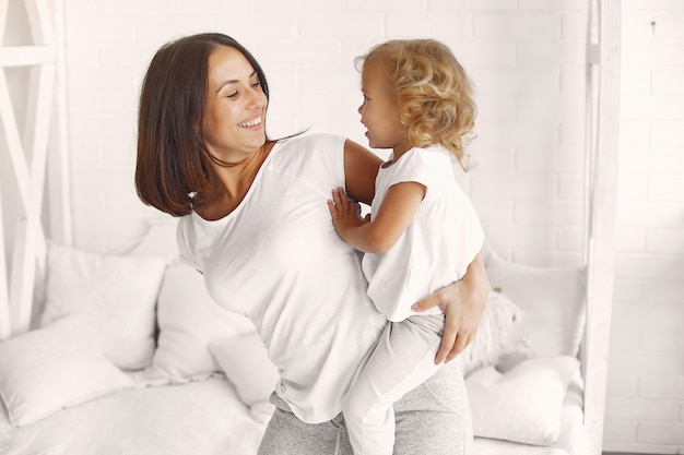 Mother and little daughter have fun at home