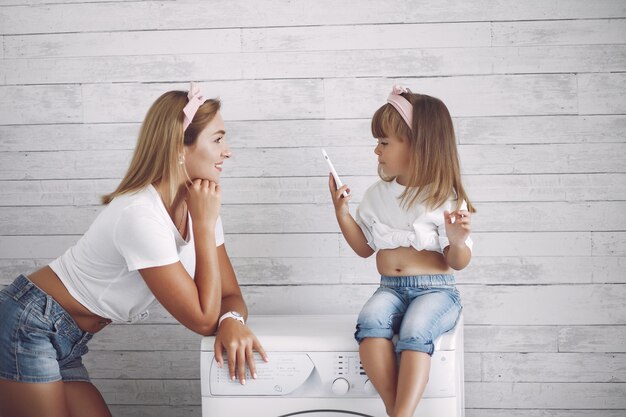 Mother and little daughter have fun at home