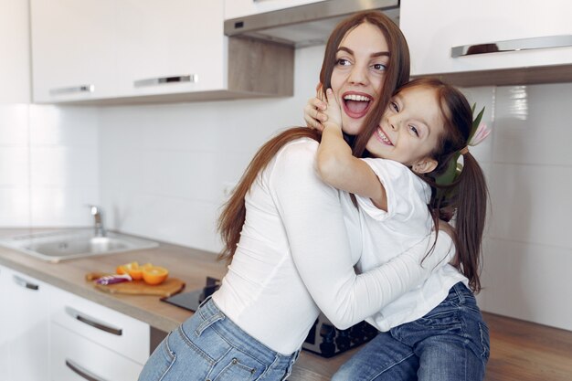 Mother and little daughter have fun at home