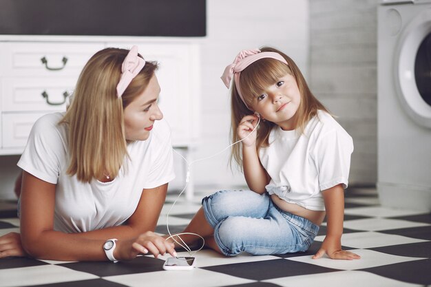 Mother and little daughter have fun at home