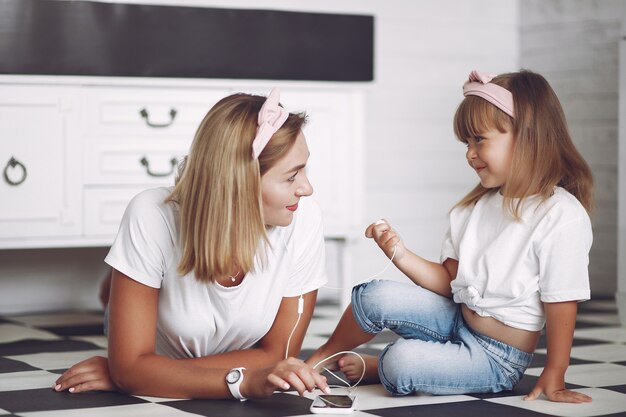 Mother and little daughter have fun at home