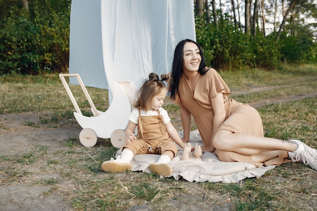 Mother and little daughter playing in a summer field