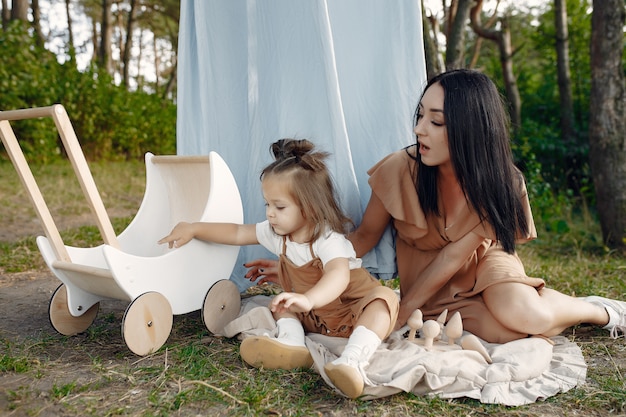 Mother and little daughter playing in a summer field