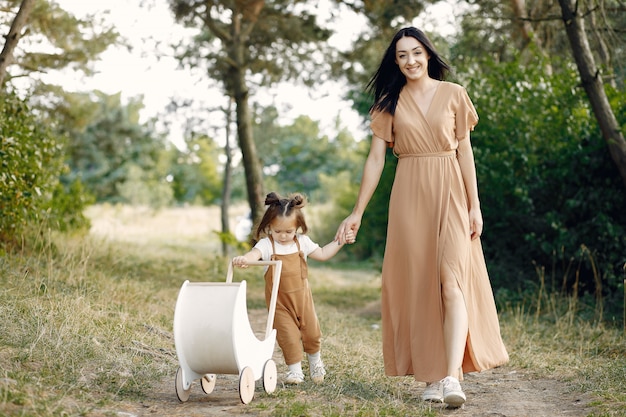 Mother and little daughter playing in a summer field