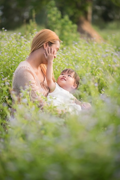 Mother and little daughter playing together in a park