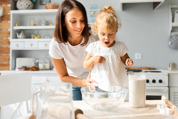 Mother and little girl cooking together