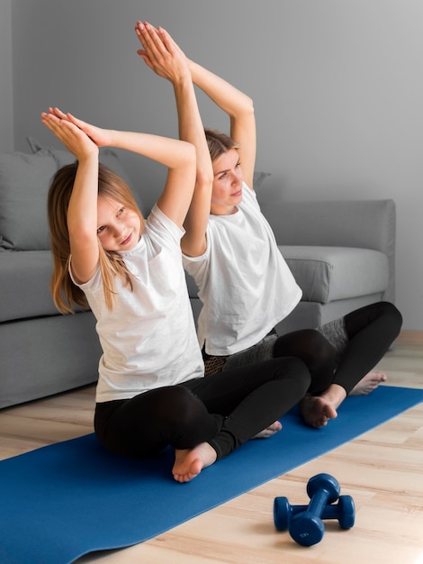 Free photo mother and little girl sport routine