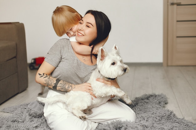 Free photo mother and little son fun at home with dog
