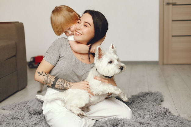 Mother and little son fun at home with dog