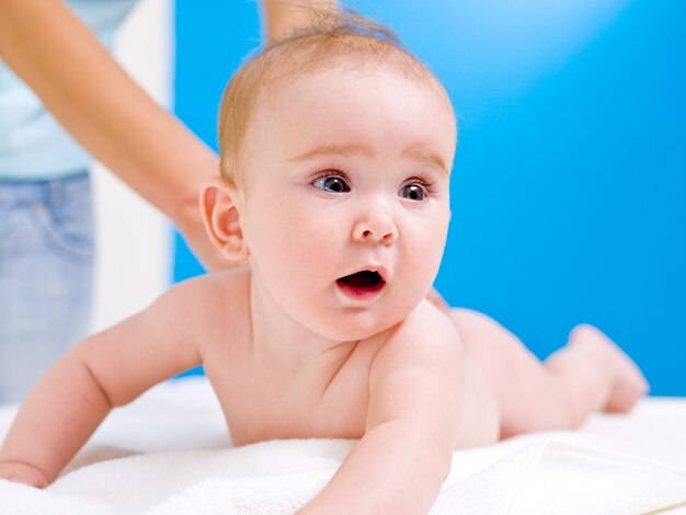 Mother massaging back of baby