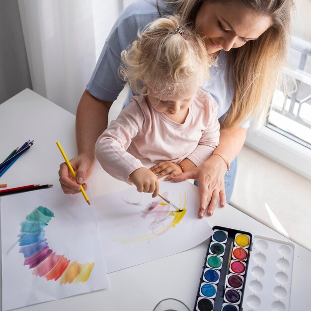 Mother painting with child at home