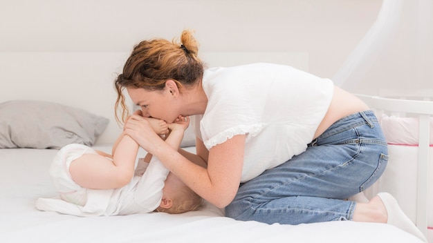 Mother playing with baby at home