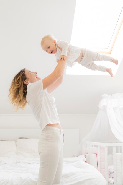 Mother playing with child at home