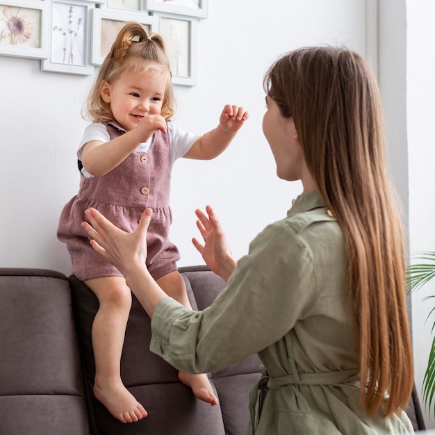 Mother playing with happy kid