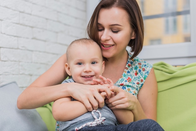 Mother playing with her son's arms