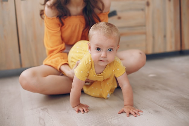 Mother playing with little daughter at home