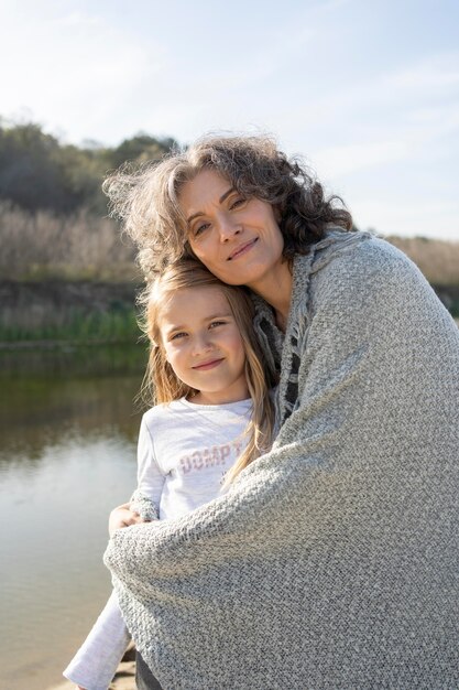 mother posing with her young daughter outdoors