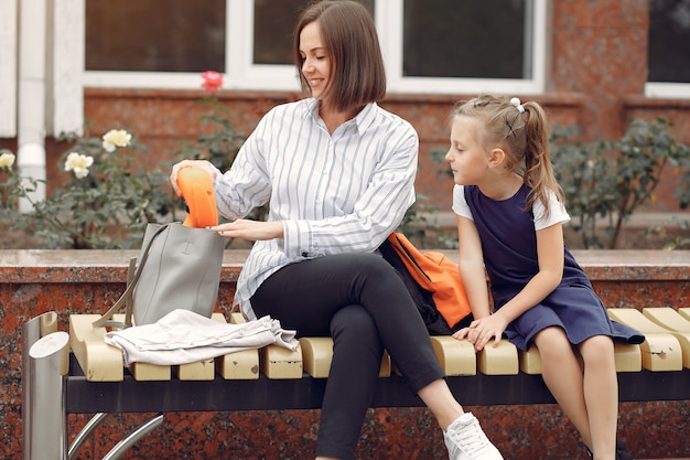 Free photo mother prepare little daughter to school