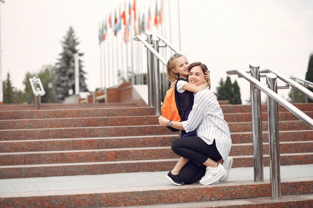 Mother prepare little daughter to school