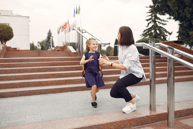 Mother prepare little daughter to school