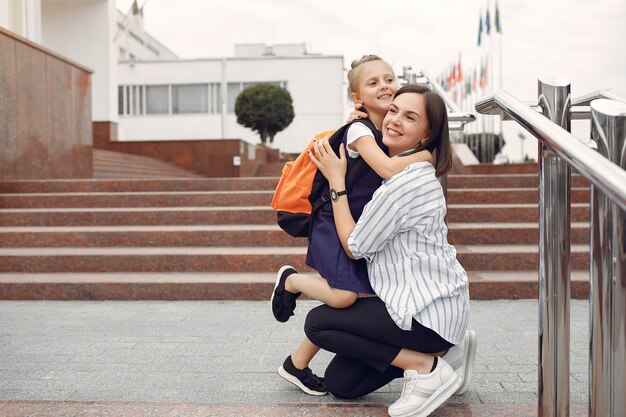 Mother prepare little daughter to school