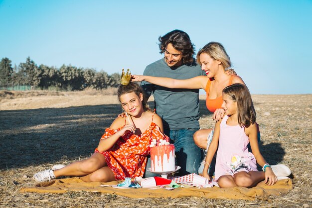 Mother putting crown on daughter