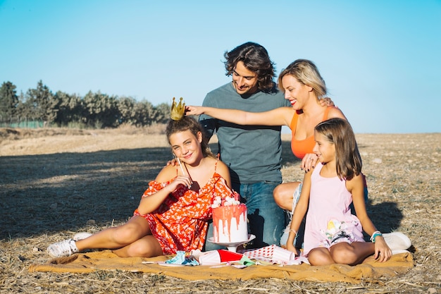 Mother putting crown on daughter