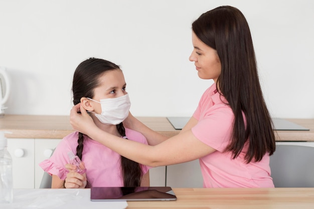 Mother putting mask on child