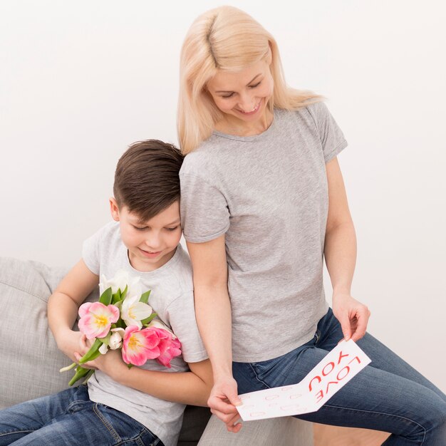 Mother reading card from son