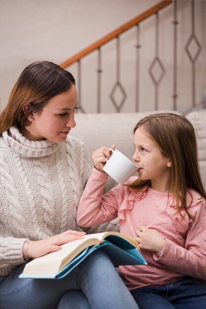 Free photo mother reading together with daughters