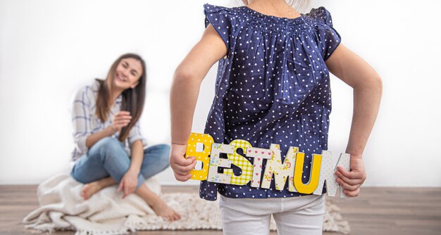 Free photo mother's day. a little cute daughter congratulates her mother