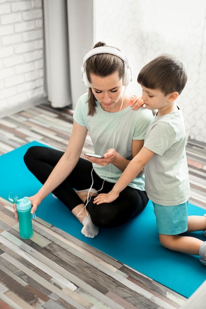 Mother showing her son sport exercises