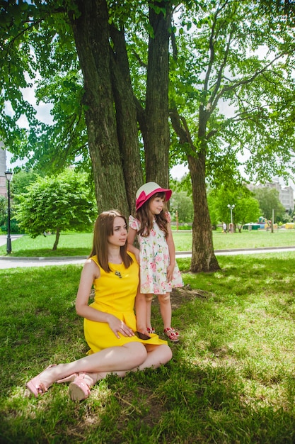 Free photo mother sitting on the floor and her daughter standing