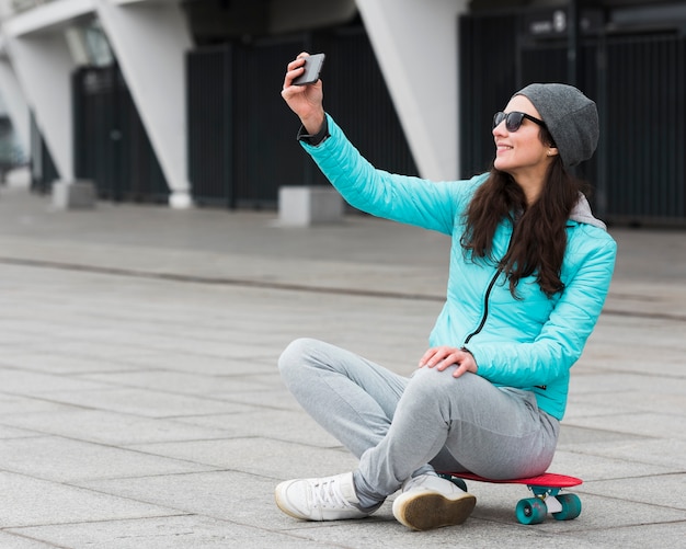 Mother on skateboard taking selfie