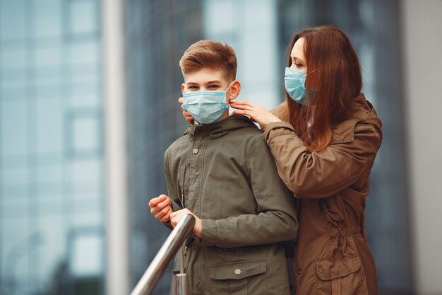 Mother and son are wearing disposable masks