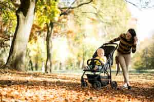 Free photo mother and son in autumn park