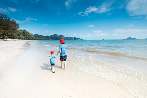 A mother and son on beach outdoors Sea and Blue sky