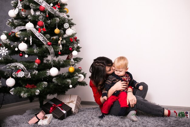 Mother and son by the christmas tree