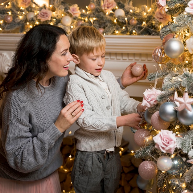 Mother and son decorating the christmas tree