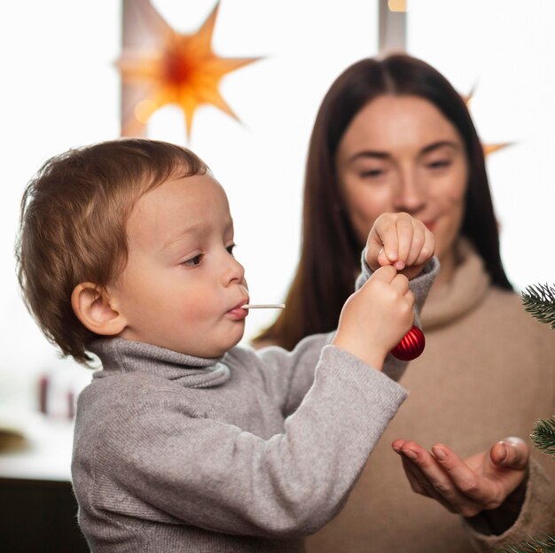 Mother and son decorating christmas tree