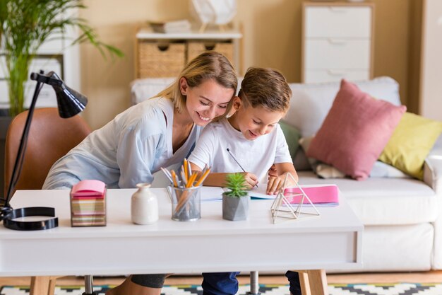 Mother and son doing homework indoors