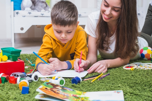 Free photo mother and son drawing